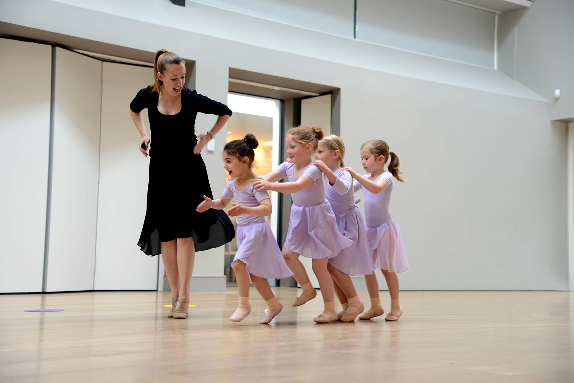 Group of young dancers practising choreography together