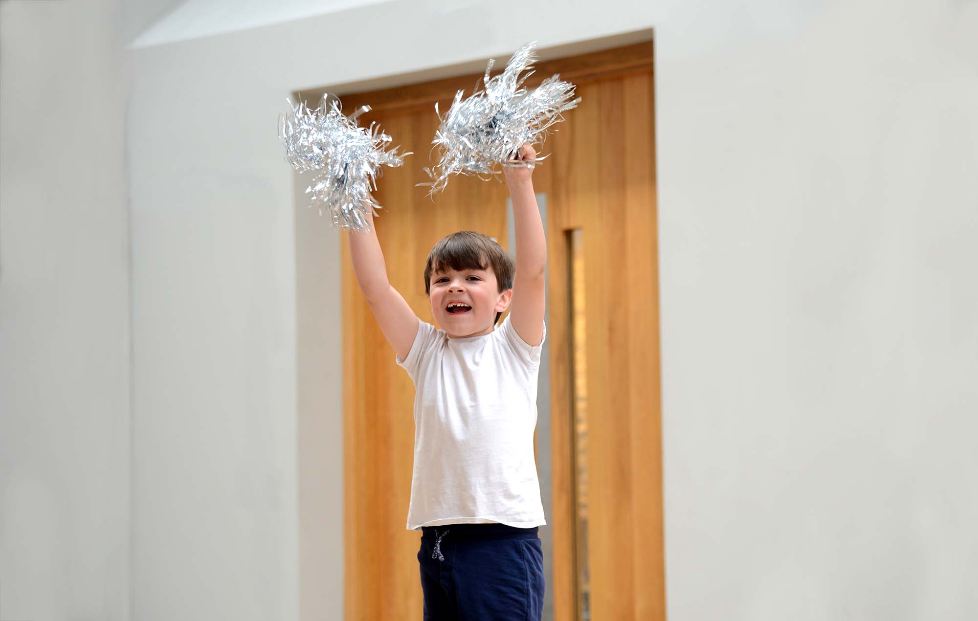 Primary school children performing ballet exercises at the barre